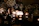 A cozy candlelit wedding table with personalized candles glowing warmly.
