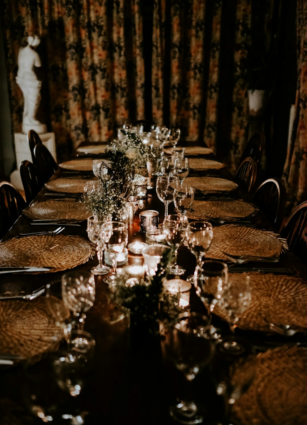 clear wine glasses on top of long dining table