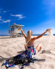 woman sitting on beach sand