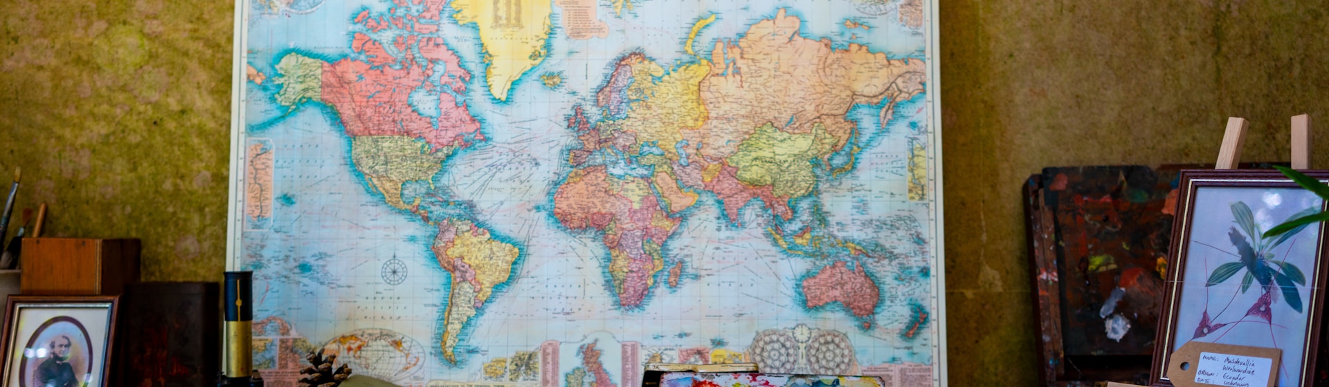world map poster near book and easel