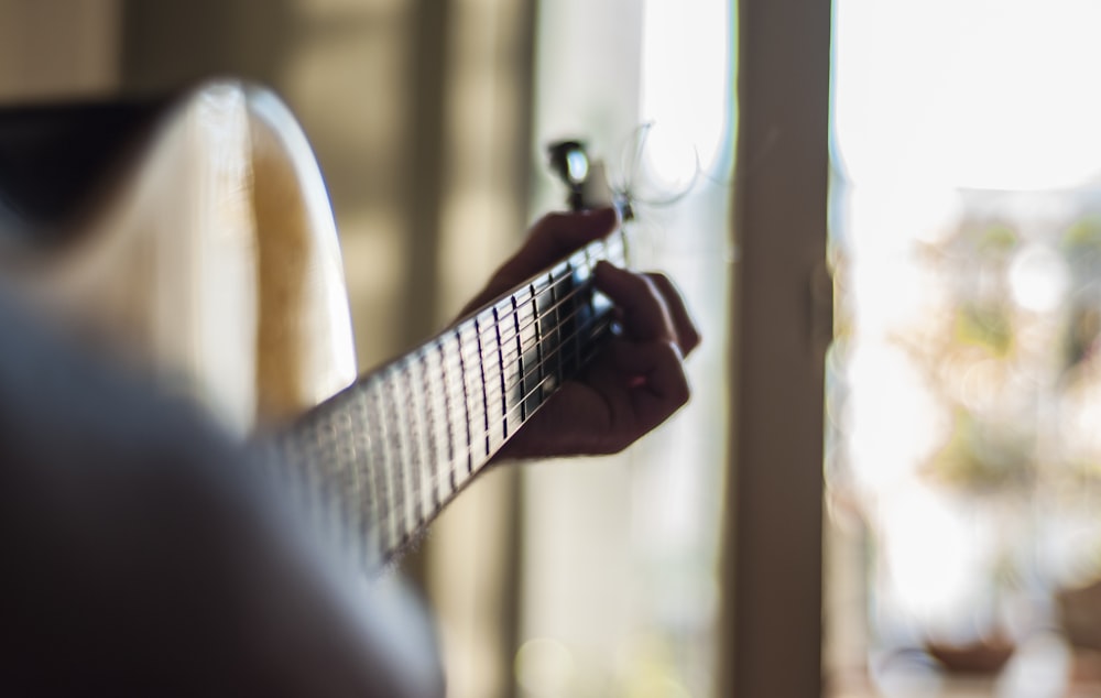 person playing guitar indoors