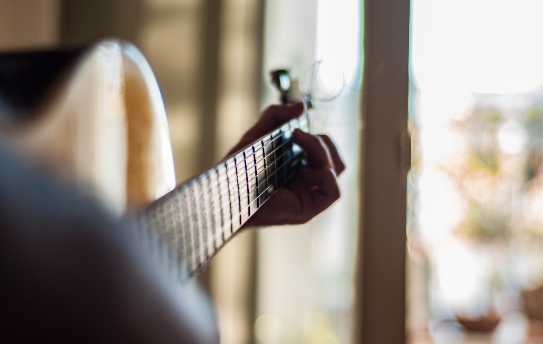 person playing guitar indoors