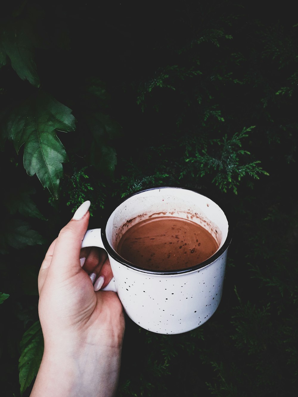 person holding white ceramic mug