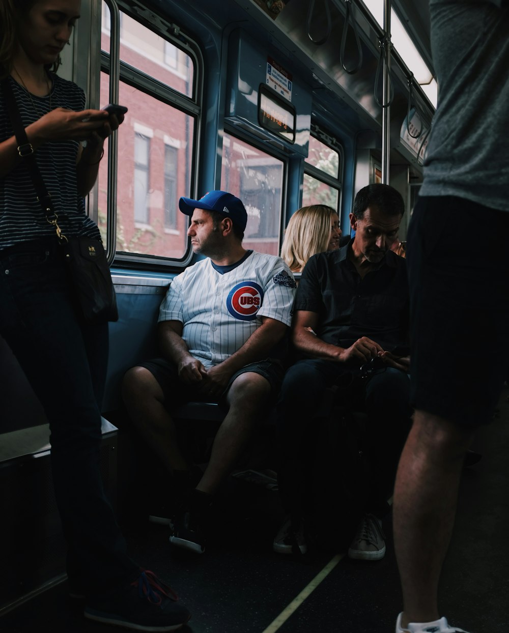 people sitting and standing inside the vehicle