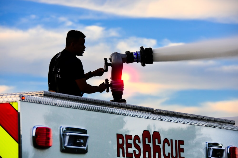 man operating water hose