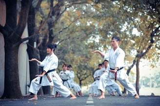 man and woman doing karate on road at daytime
