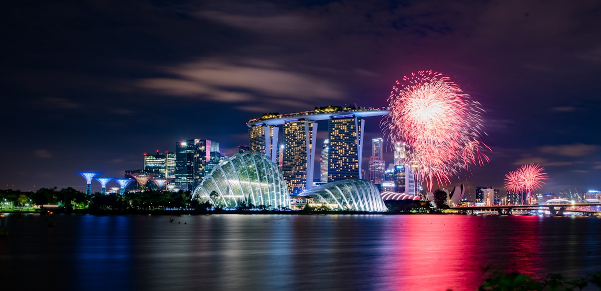 Singapore July — fireworks burst over Marina Bay Sands and the city skyline at night