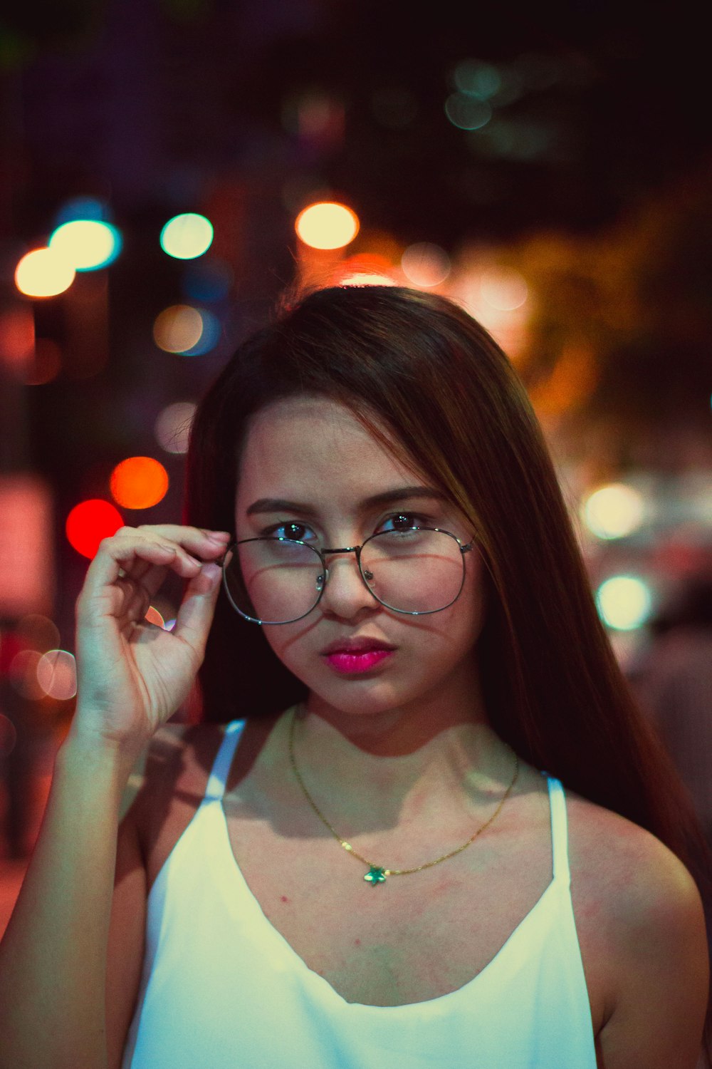 woman holding eyeglasses