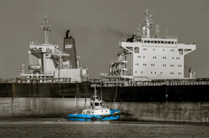 Shore power connection setup powering a docked cargo ship, reducing emissions.