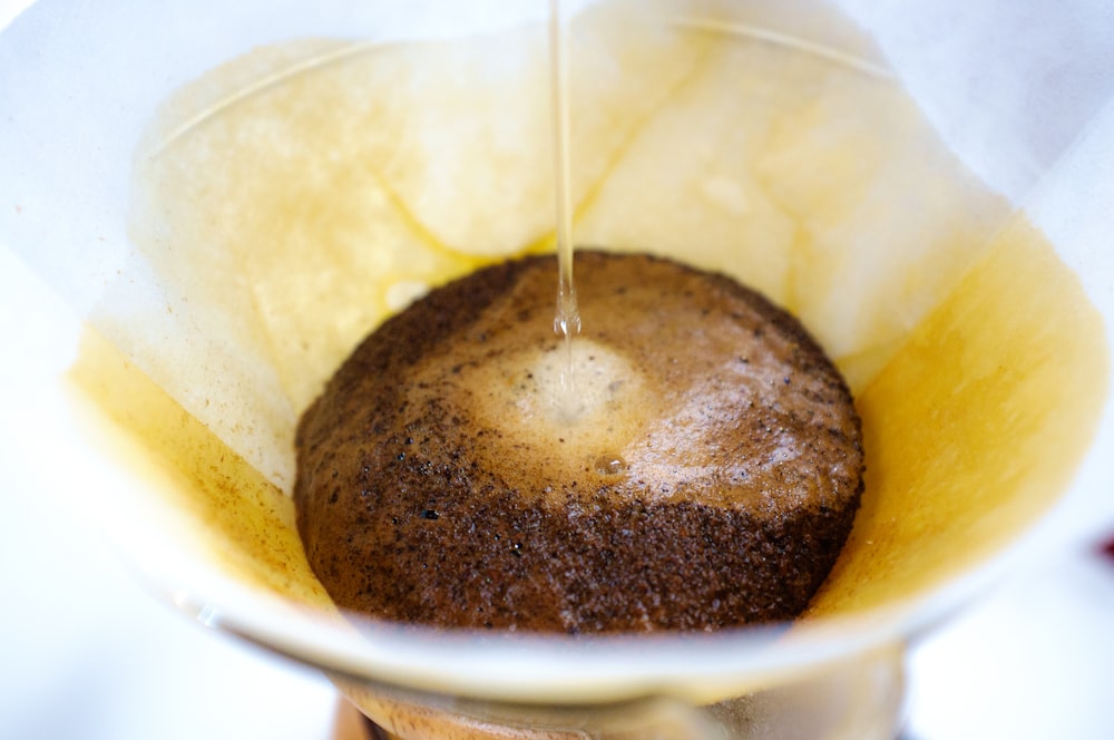 water poured on brown coffee