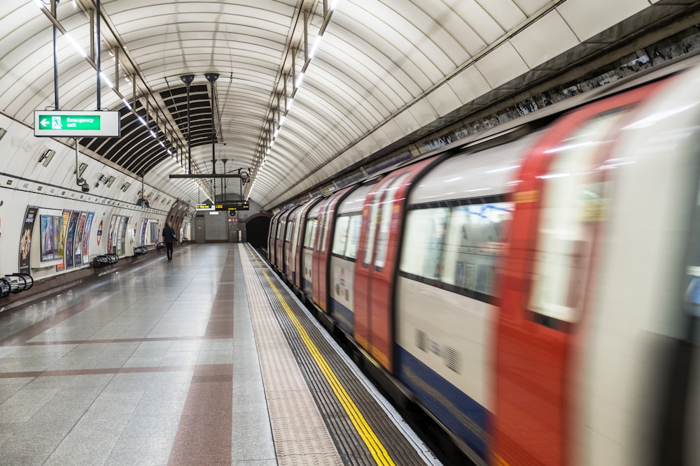 running red and white train in the subway