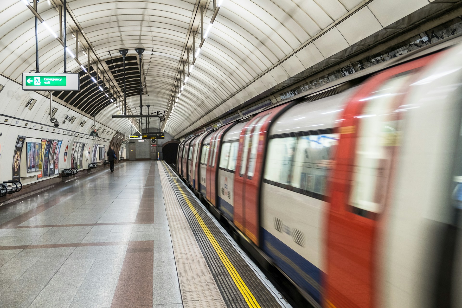 running red and white train in the subway