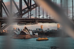 white boat beside Sydney Opera HOuse