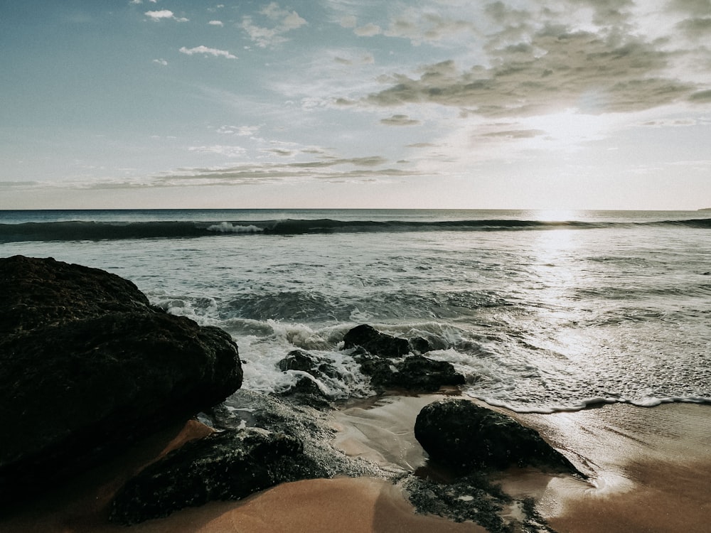 a view of the ocean from a rocky shore