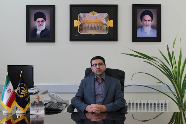 Portrait of Julián Fernández in a modern office setting with financial charts in the background.