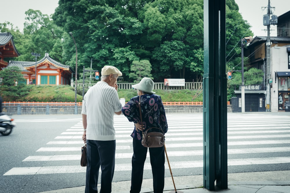 man and woman standing in front of pedestrian line