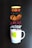 Various dried fruit slices and other ingredients are arranged in a vertical line above a white mug with a green leaf decoration and a blue zig-zag pattern. These ingredients include a slice of dried ginger, red fruit rings, dark dried fruit, brown slices, red petals, and small white cubes.