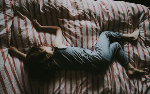 A 2 year old toddler resisting bedtime in a cozy bedroom