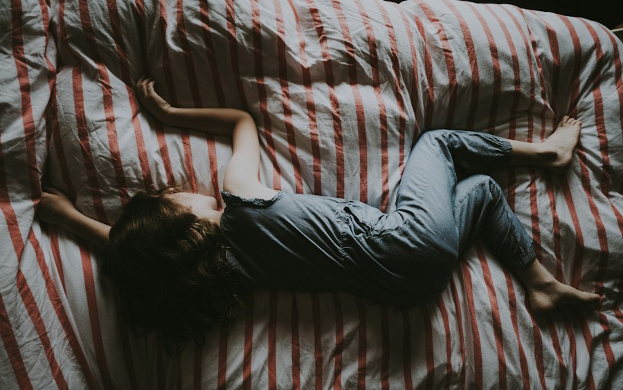 A 2 year old toddler resisting bedtime in a cozy bedroom