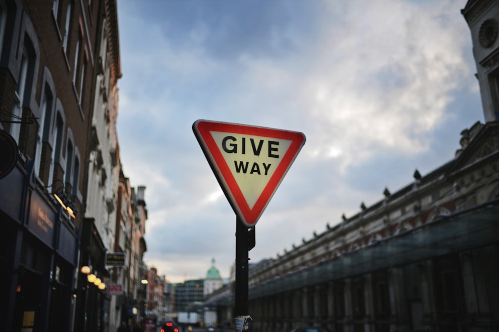 red and white Give Way signage post on street