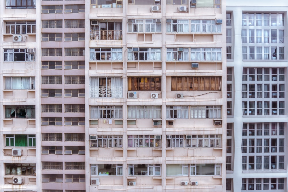 brown building beside white building