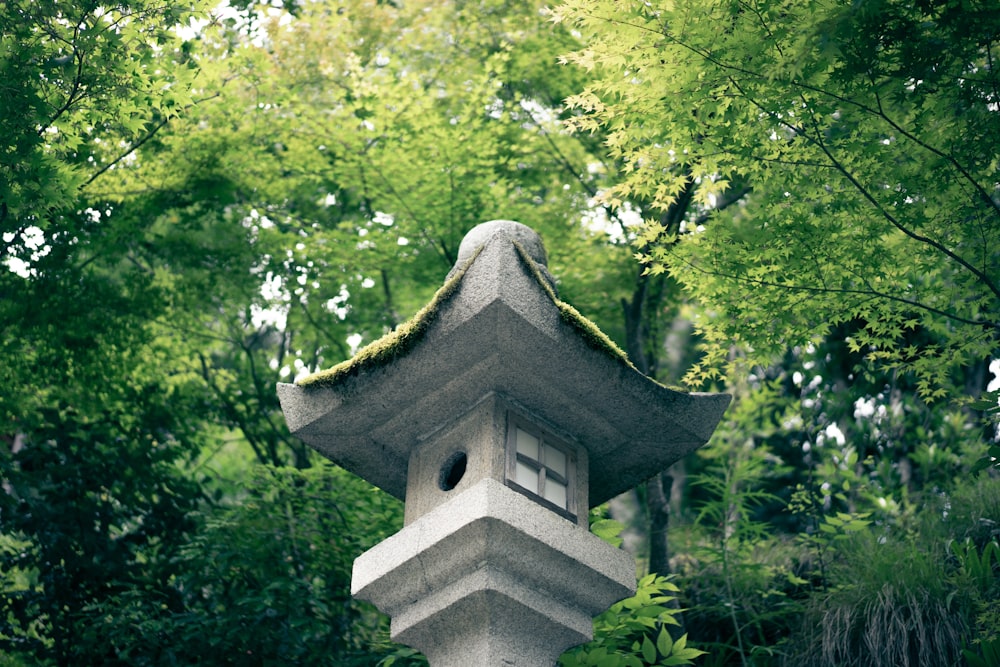 gray concrete nestbox surrounded by green leafed trees