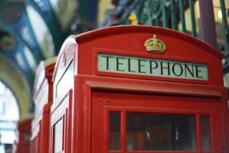 Close-up of traditional Moroccan mosaic tiles next to a classic British red telephone box.