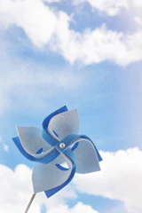 A colorful pinwheel spinning in a gentle breeze on a sunny Texas porch.