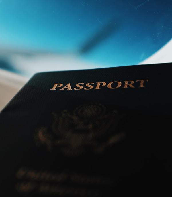silhouette of passport booklet with airplane window background
