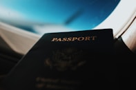 silhouette of passport booklet with airplane window background