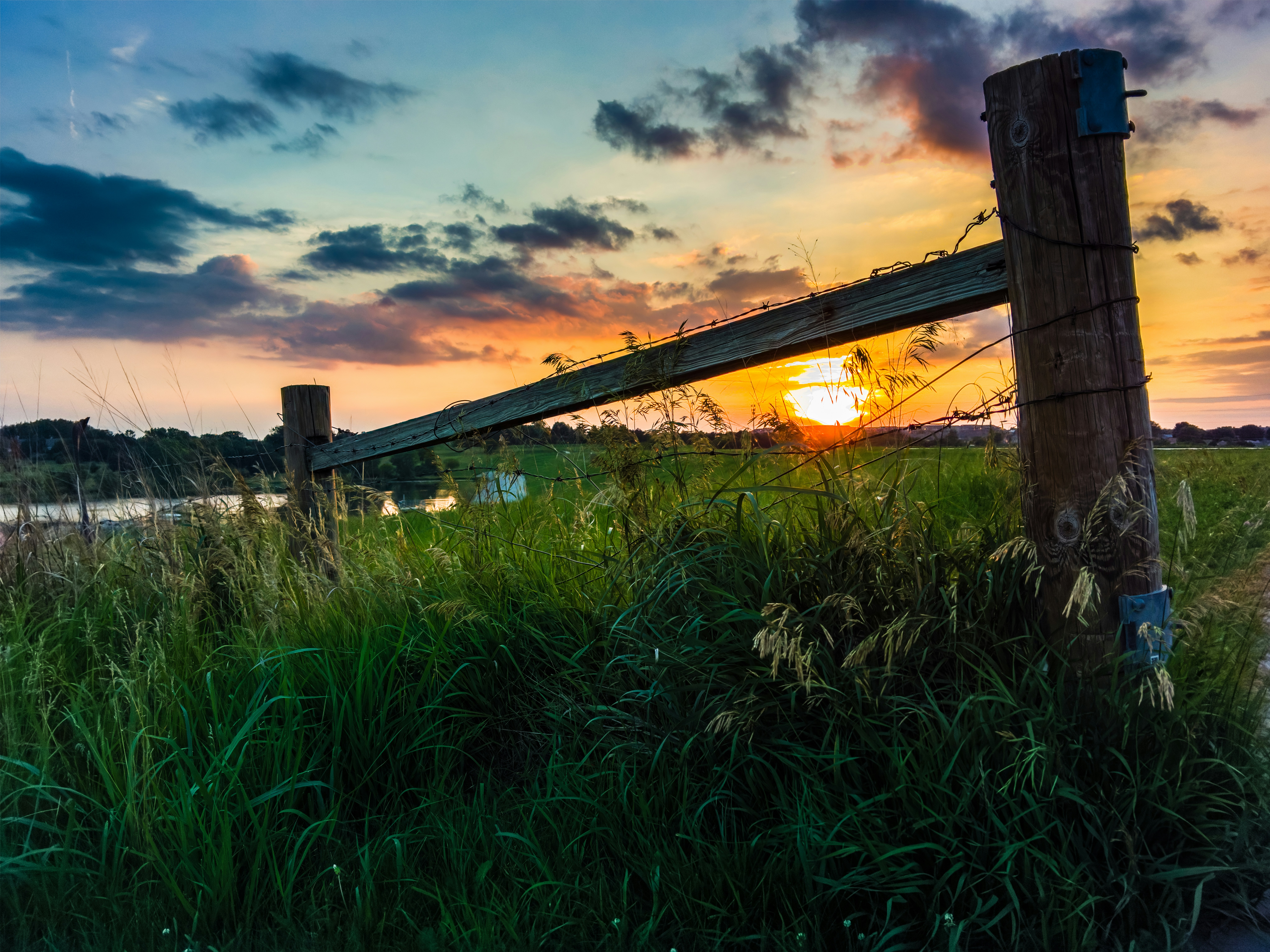 It was too nice of a sunset not to record, but the skyline was not the prettiest. However, I came across an old fence that I was able to position to block out the worse of the skyline and provide some foreground interest.