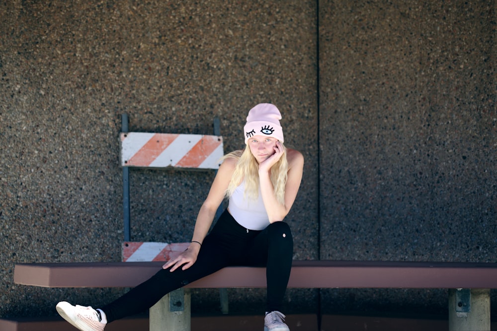 woman sitting on brown bench