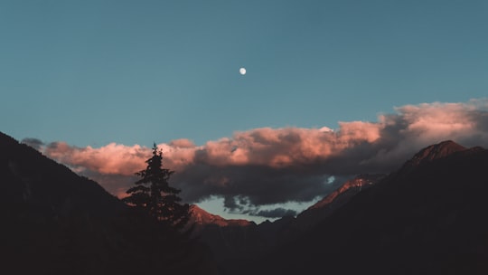 silhouette photo of mountain with clouds in Schmitten (Albula) Switzerland