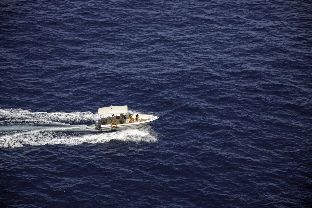 aerial photography of people riding boat at daytime, Speedboat with three women bathing