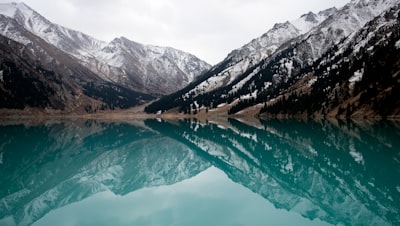 lake surrounded with mountains during daytime kazakhstan teams background