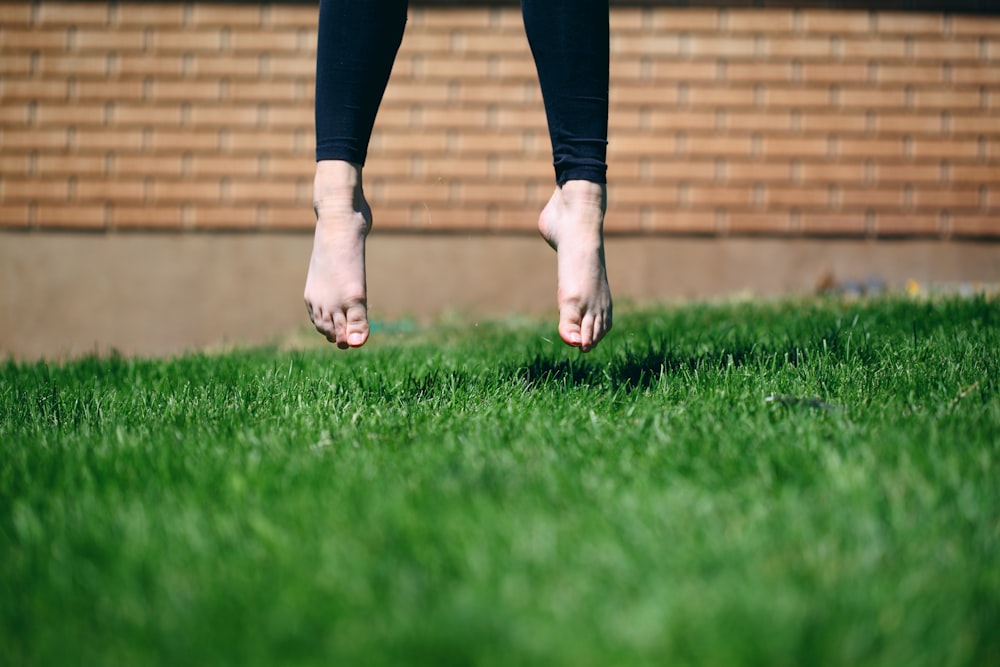 person jumping on grass outdoor