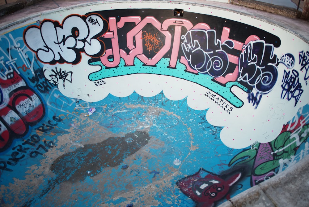 white, pink, and blue mural on in-ground pool