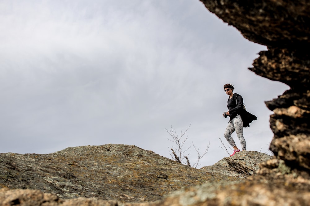 man standing on rock during day