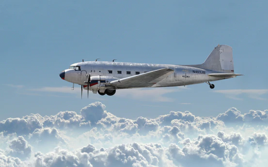 A vintage Varig airplane soaring gracefully against a clear blue sky.