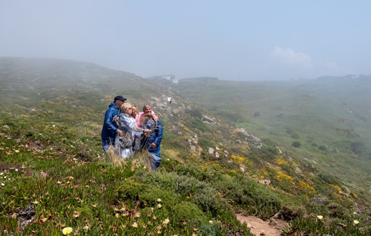 group of people standing on mountain in Cabo da Roca Portugal