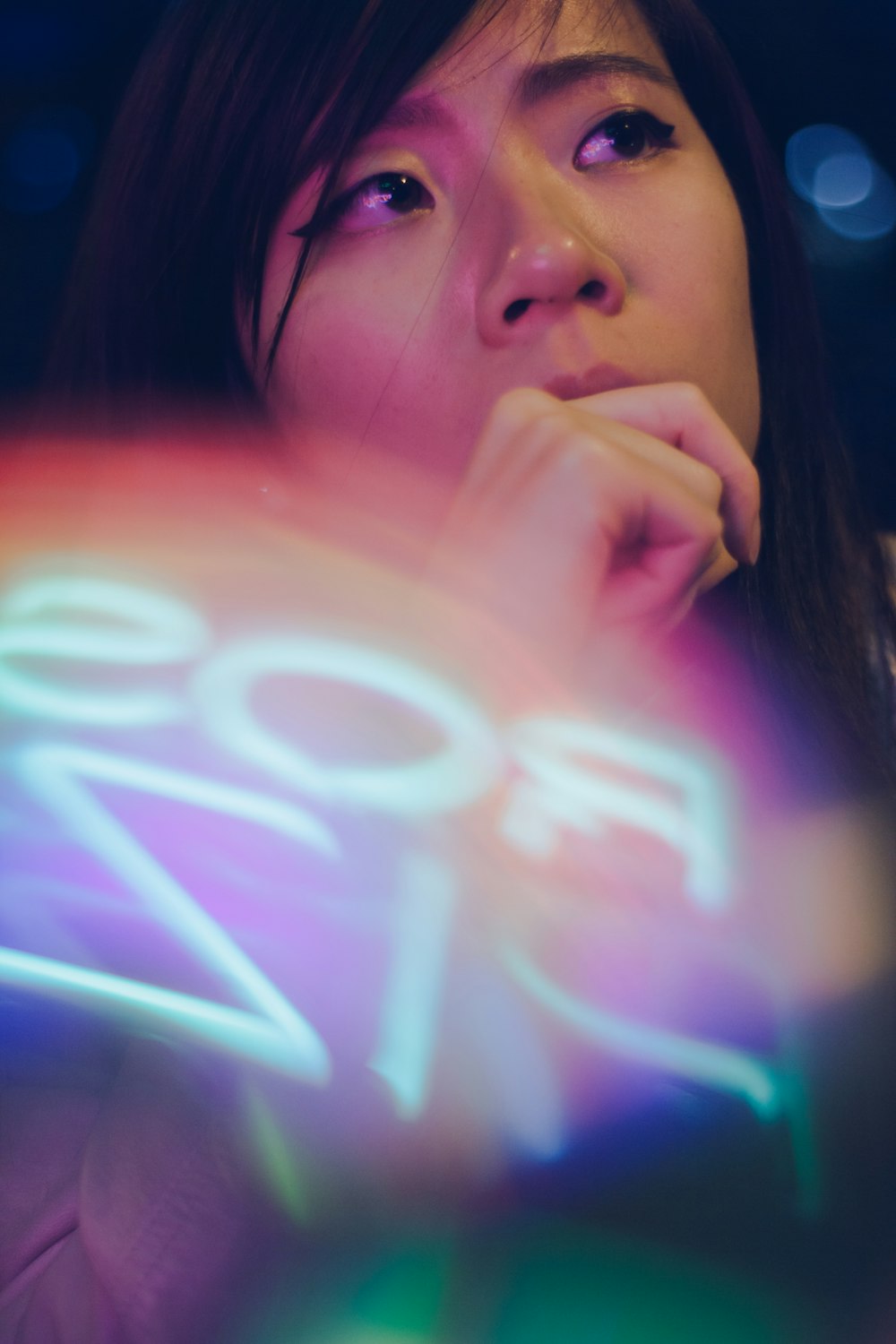 closed-up photography of woman in front of LED signage