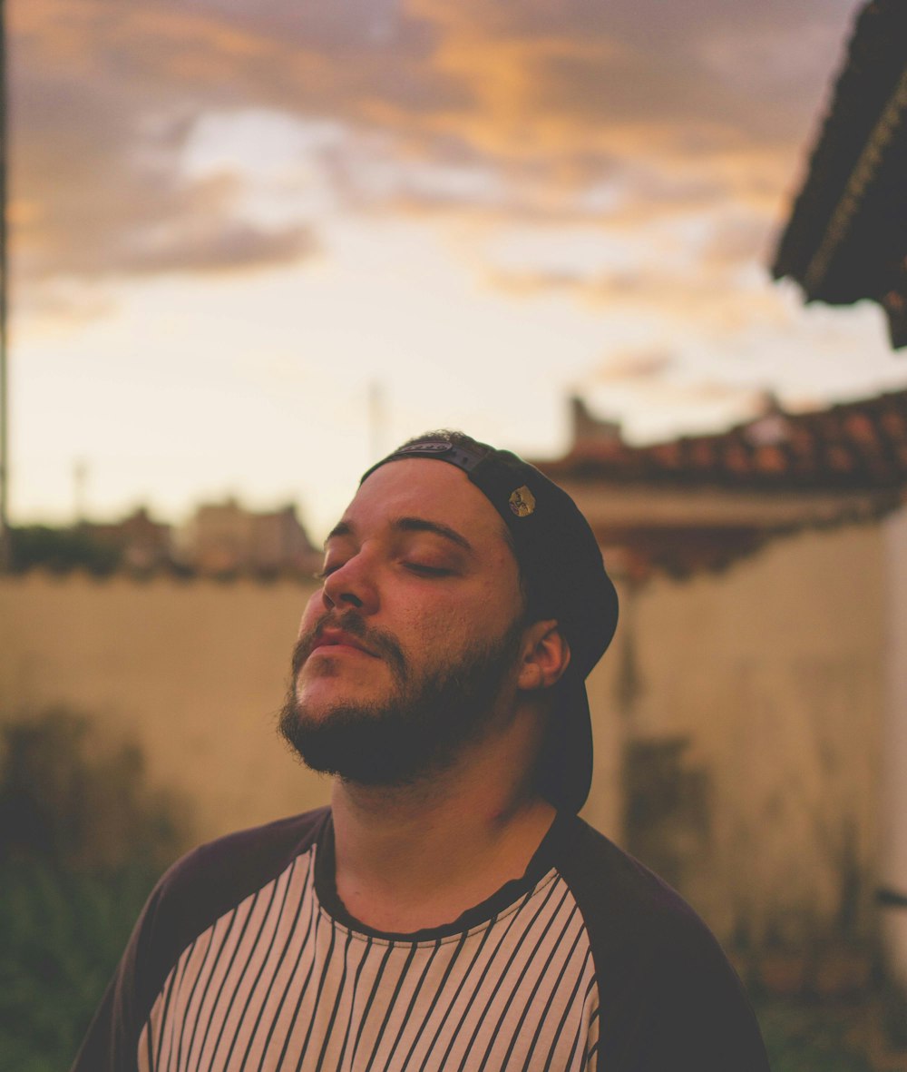 a man with a beard wearing a hat