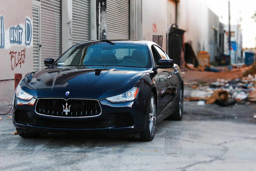 black Maserati coupe near wall