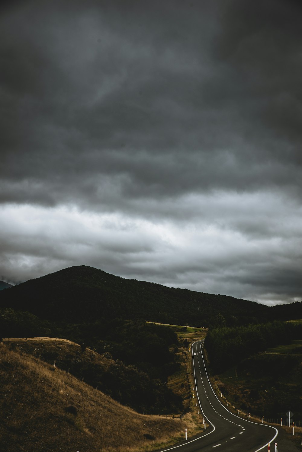 top view of gray roadway between hills