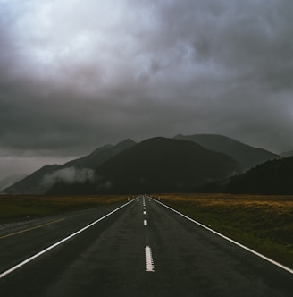 gray road under cloudy sky