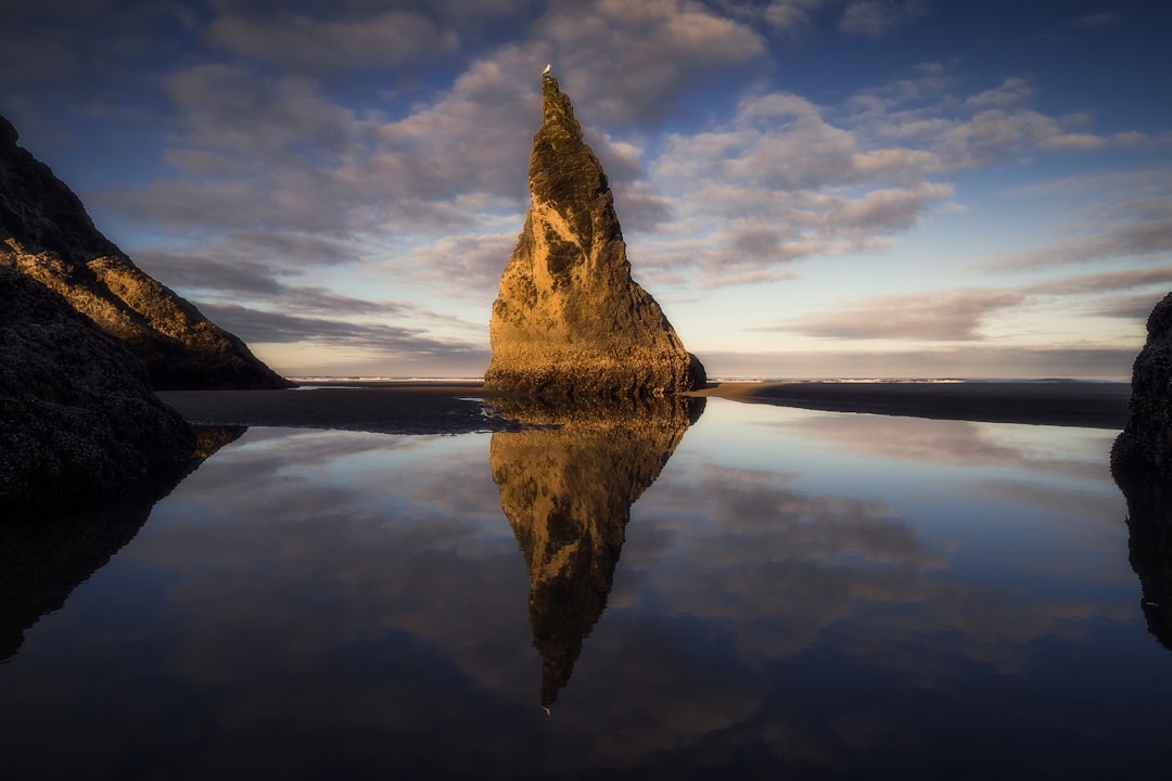 reflection of rock formation on body of water