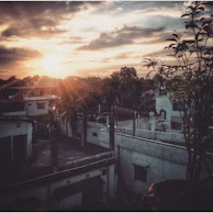 Sunset over the rooftops of Villa Ballester, casting a golden glow on the neighborhood.