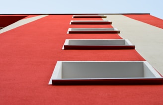 red and white paint wall at daytime