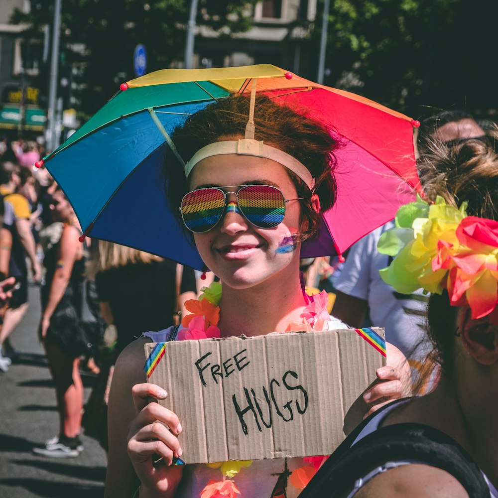 person holding Free Hugs signage