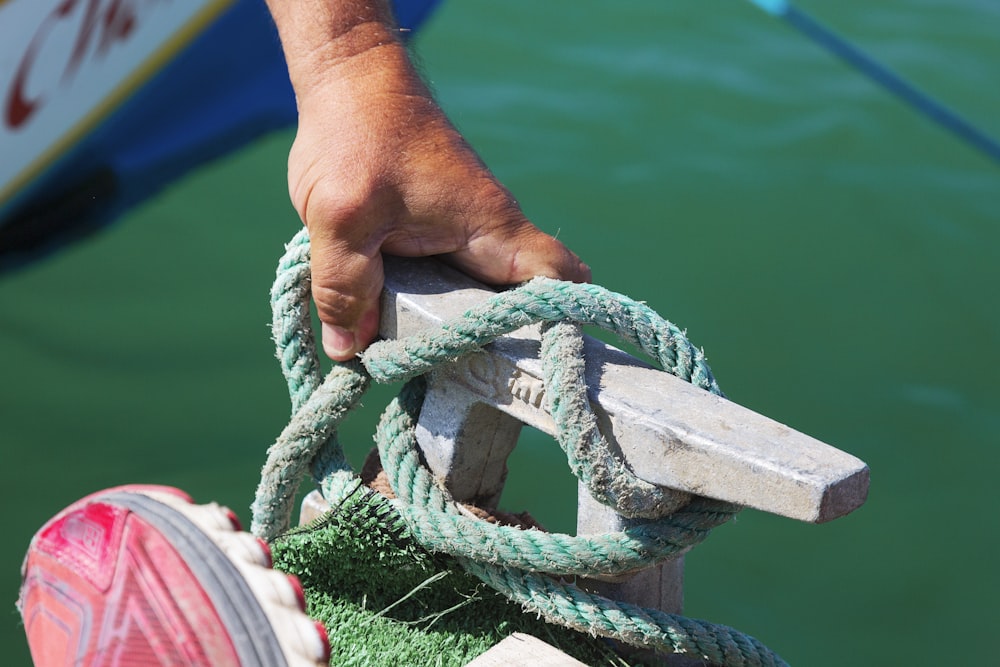 person holding green rope